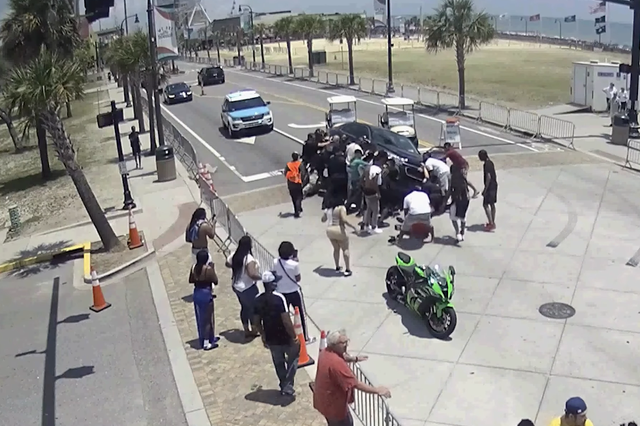 <p>Officers and bystanders in Myrtle Beach who saw a motorcyclist get pinned under a car rush to rescue the man by working together to lift the vehicle off his body.</p>