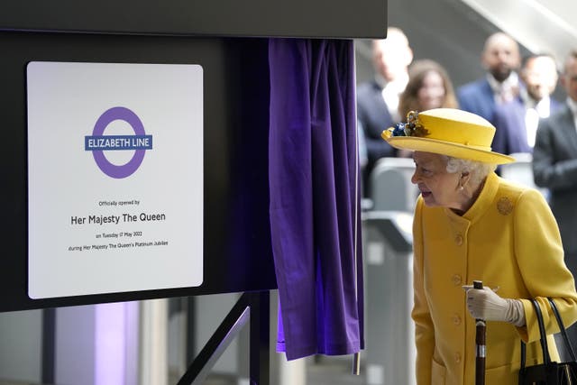 The Queen unveils a plaque to mark the Elizabeth line’s official opening (Andrew Matthews/PA)