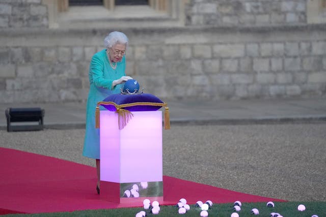 Queen Elizabeth II symbolically leads the lighting of the principal Jubilee beacon at Windsor Castle, as part of a chain of more than 3,500 flaming tributes to her 70-year-reign (Steve Parsons/PA).