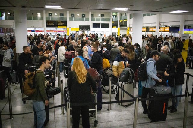 <p>Travellers queue at Gatwick airport on Tuesday</p>