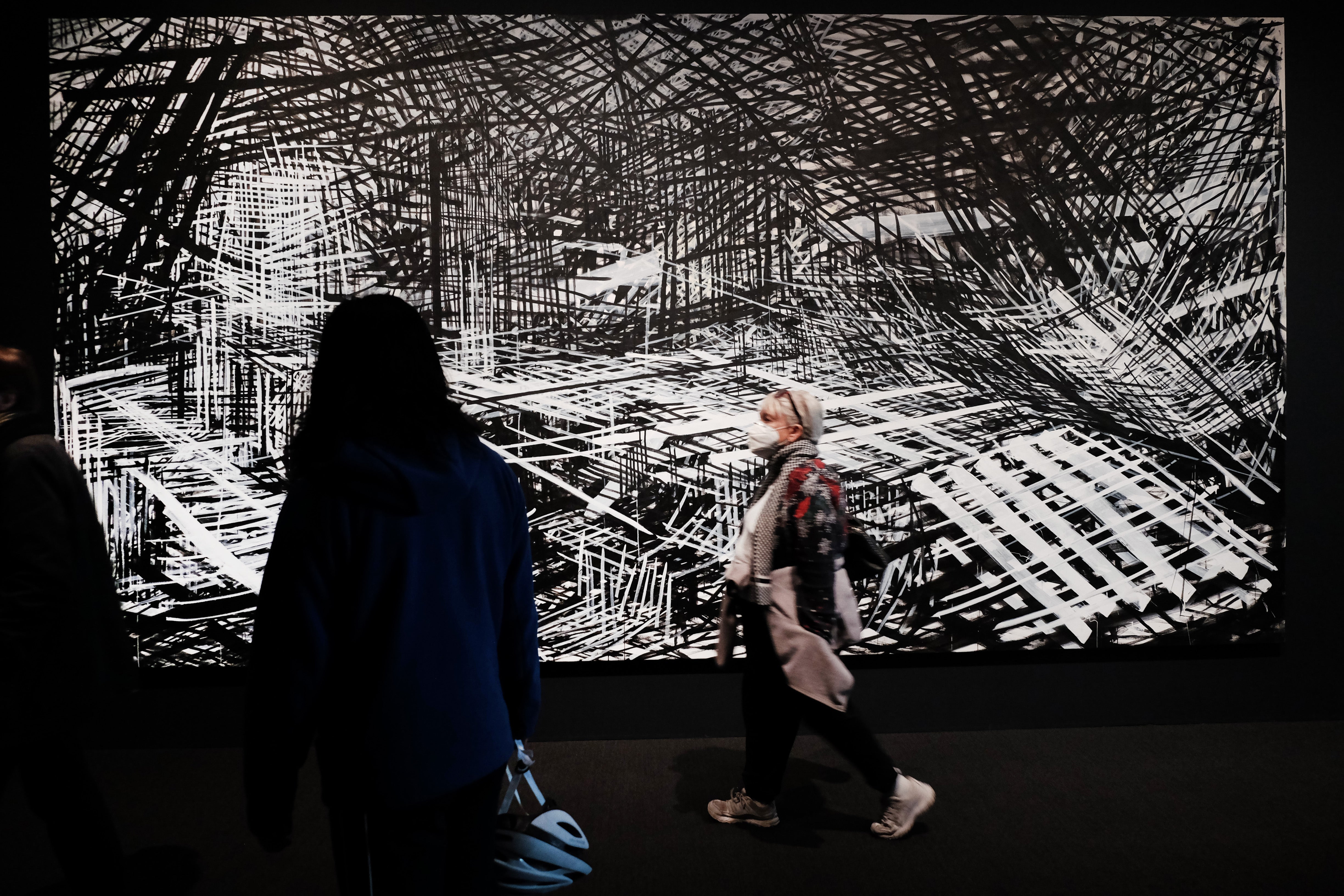 A work by artist Denyse Thomasos is displayed as people walk through the Whitney Biennial show at the Whitney Museum of Art on 6 April 2022 in New York city