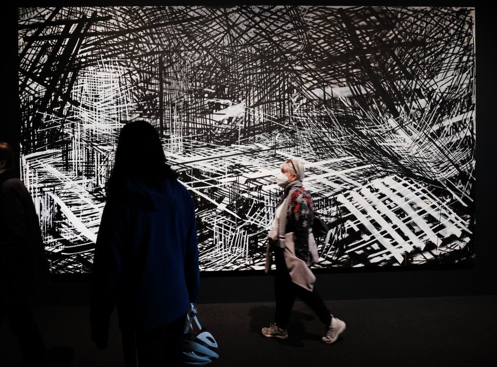 <p>A work by artist Denyse Thomasos is displayed as people walk through the Whitney Biennial show at the Whitney Museum of Art on 6 April 2022 in New York city</p>