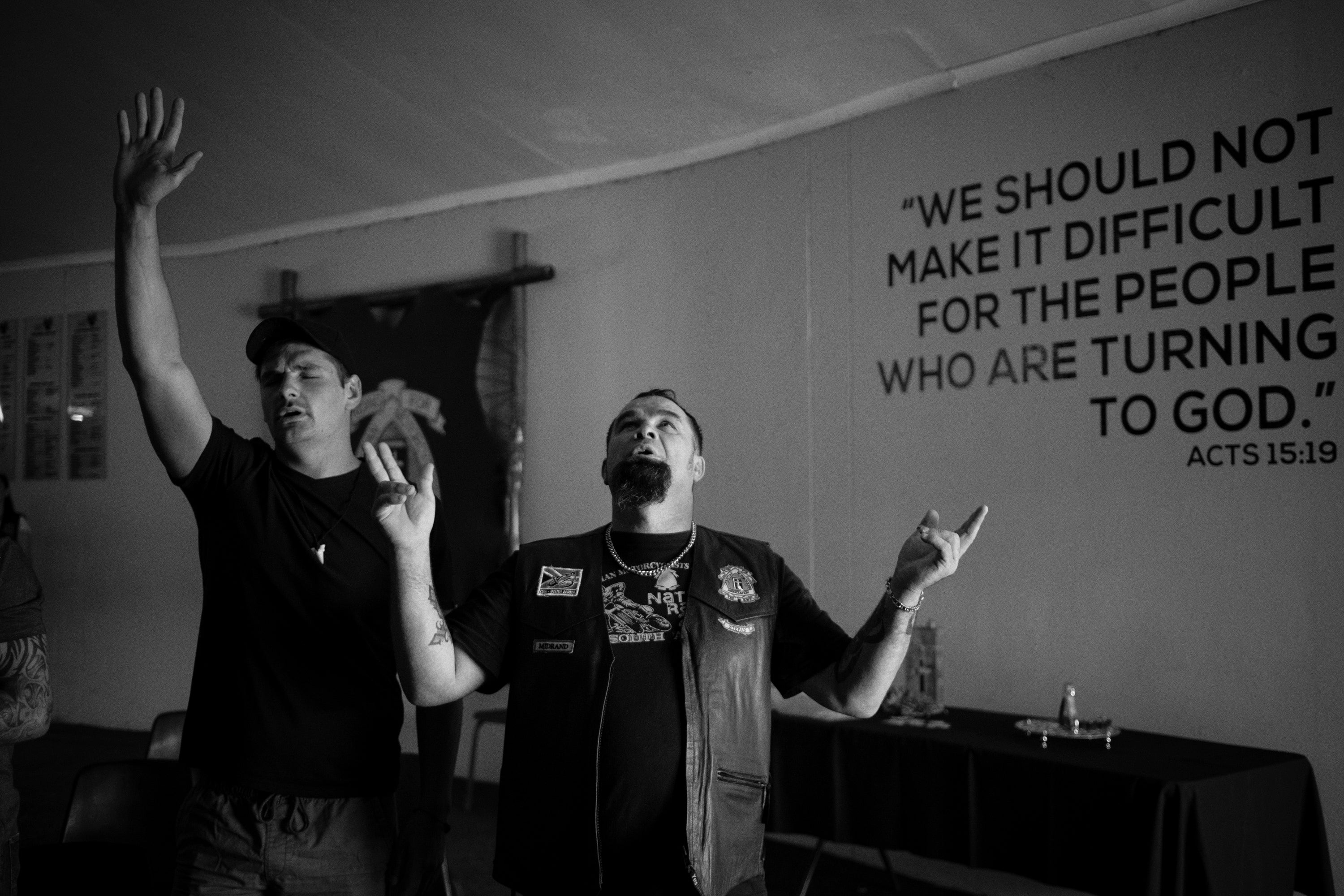 A CMA member and his friend pray during a weekly church service in Midrand, Johannesburg