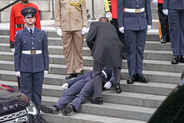 A military personnel faints ahead of the National Service of Thanksgiving (Kirsty O’Connor/PA)