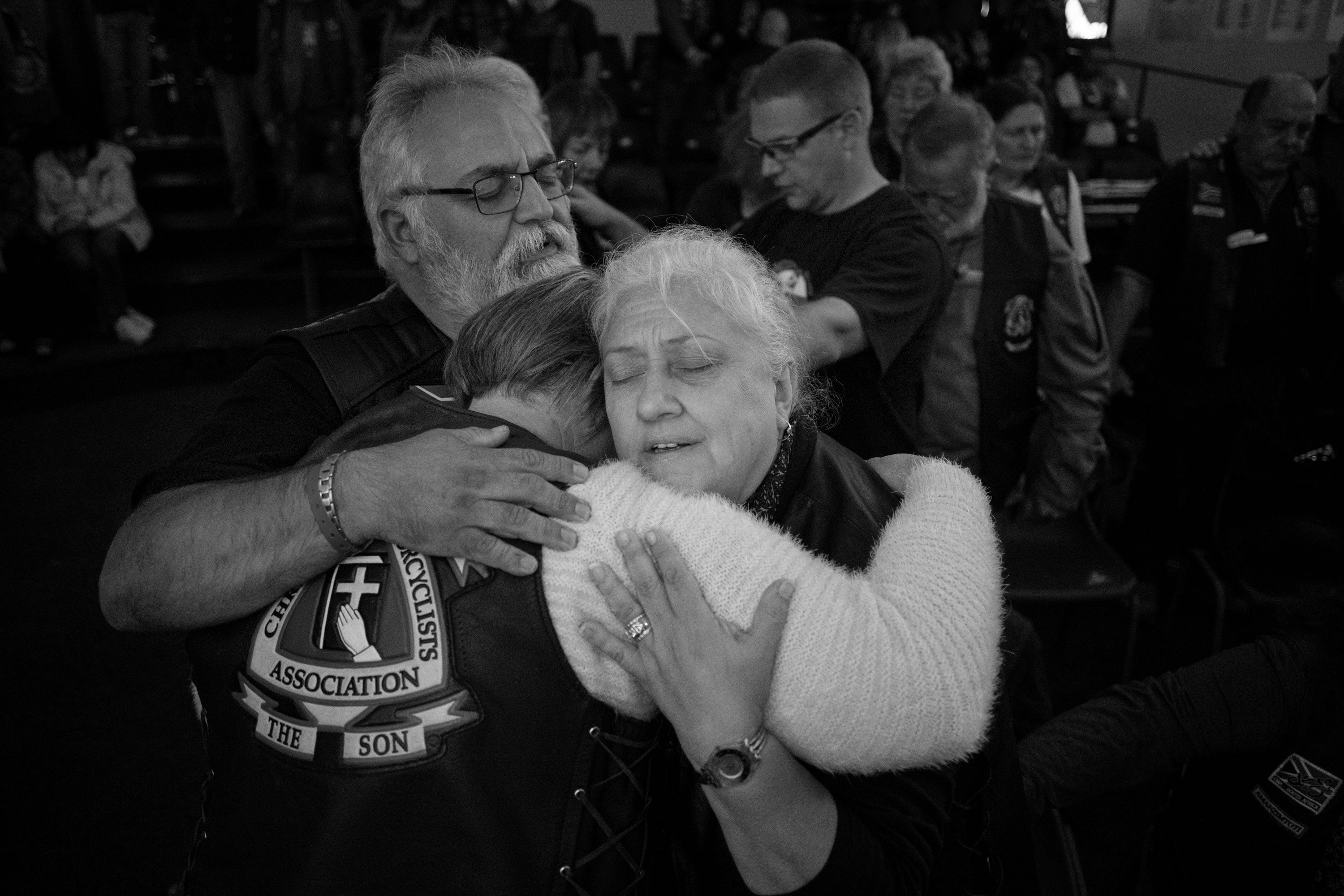 Three members of the CMA hug each other during the annual CMA rally