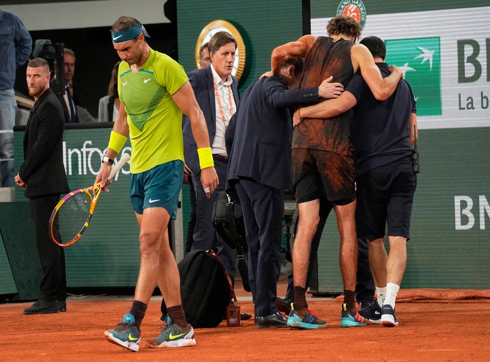 Rafael Nadal walks back as Alexander Zverev is helped off (Michel Euler/AP)