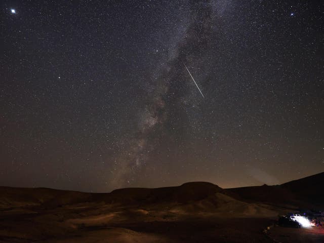 <p>The Milky Way galaxy is pictured as a Perseid meteor streaks across the sky above the Negev desert near the Israeli city of Mitzpe Ramon, on August 12, 2021</p>