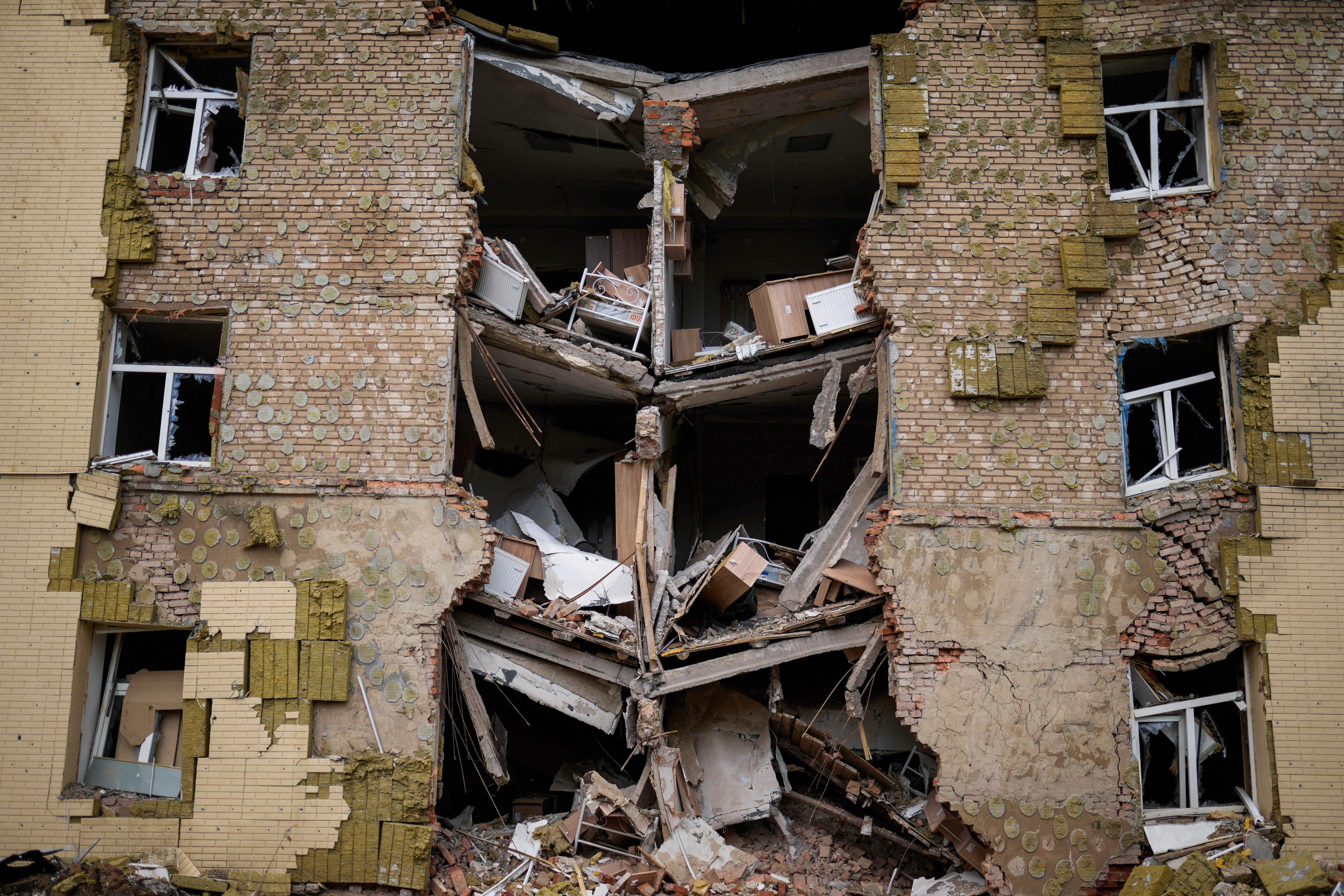 Debris hangs from a residential building heavily damaged in a Russian bombing in Bakhmut