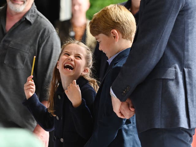 <p>Princess Charlotte laughs as she conducts a band next to her brother, Prince George,  during their visit to Cardiff Castle</p>