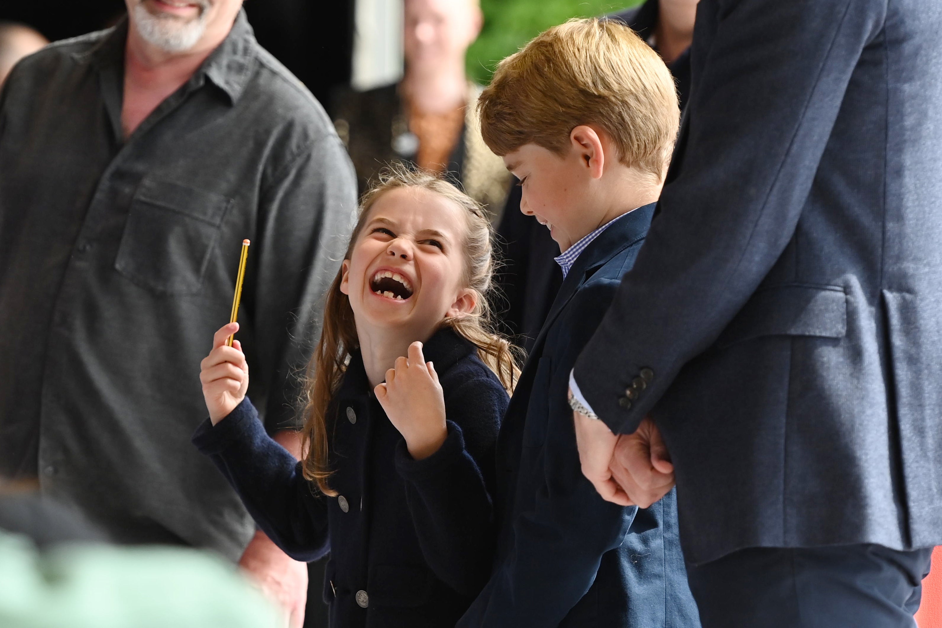 Princess Charlotte laughs as she conducts a band next to her brother, Prince George, during their visit to Cardiff Castle (Ashley Crowden/PA)