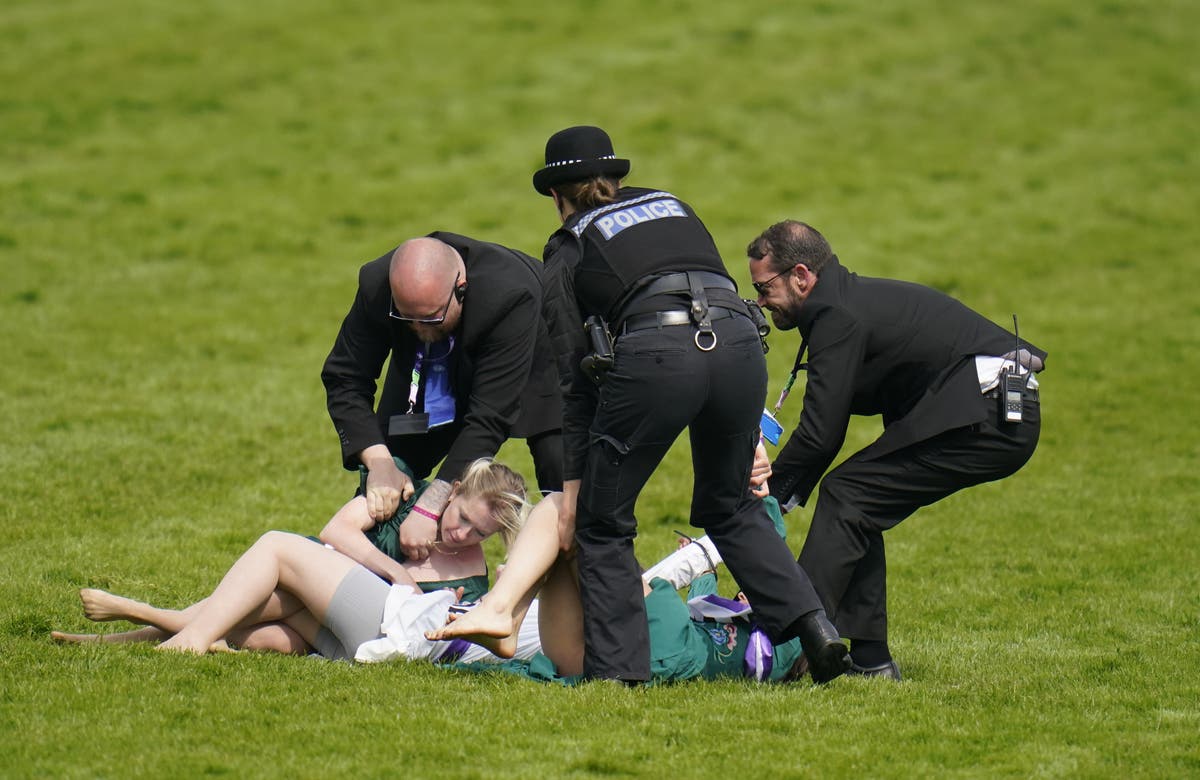 Animal activists taken away by police after running on track at Epsom Derby