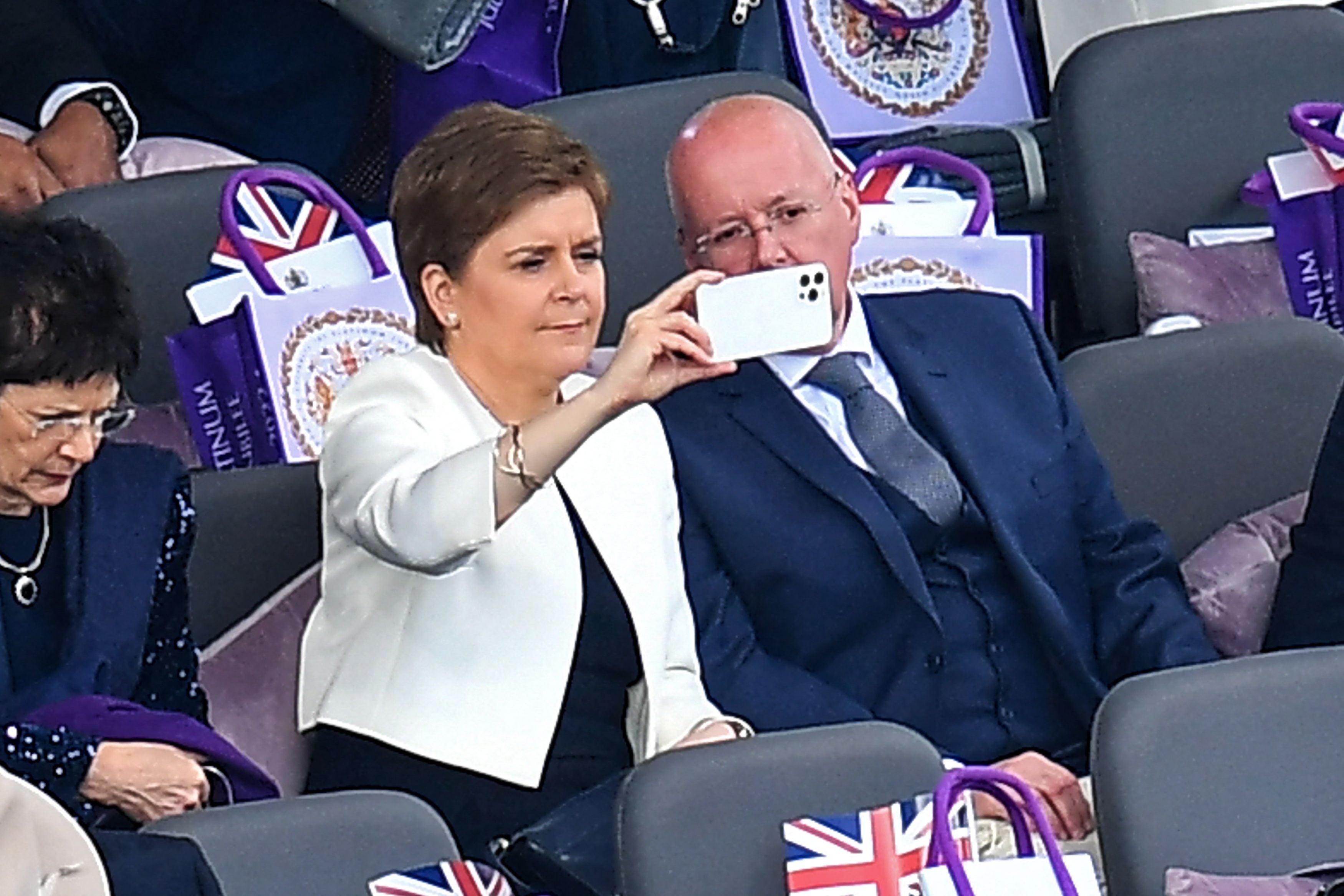 Scotland's First Minister Nicola Sturgeon and her husband and current chief executive officer of the Scottish National Party Peter Murrel take their seats for the Platinum Party