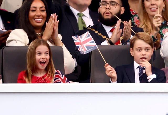 Charlotte, with George, reacts during the concert (Henry Nicholls/AP/PA)
