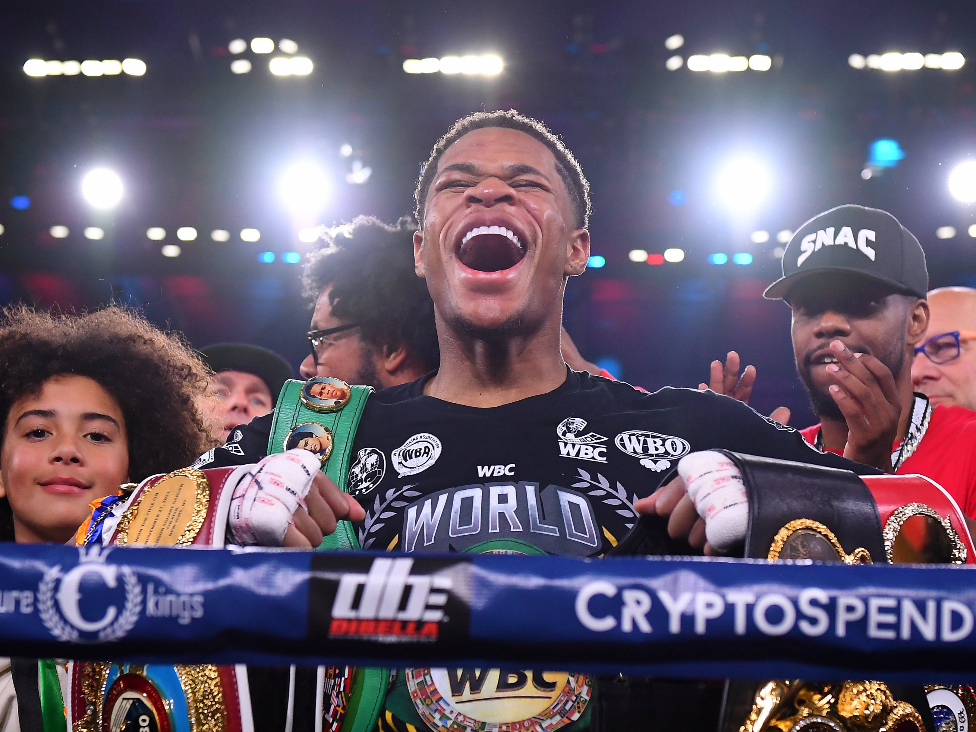 Devin Haney celebrates becoming undisputed lightweight champion against George Kambosos Jr