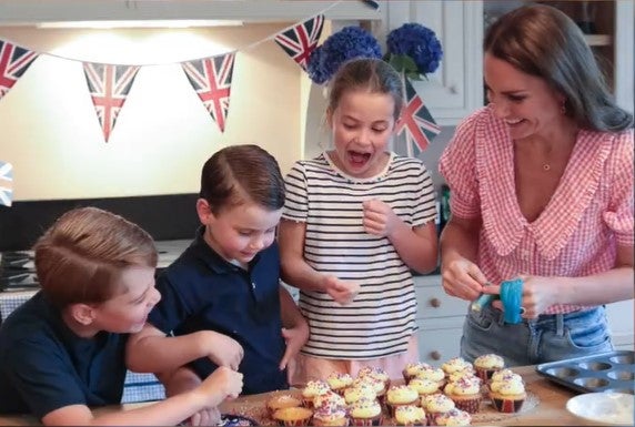 The children helped their mother ice the cupcakes