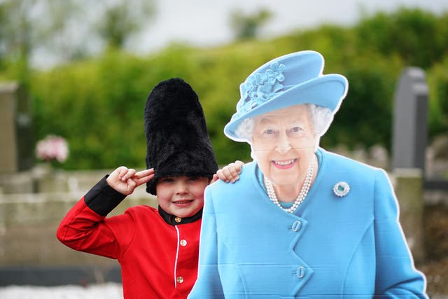 Noah McKnight, five dressed as a Foot Guard, with a cardboard cut-out of the Queen (Brian Lawless/PA)