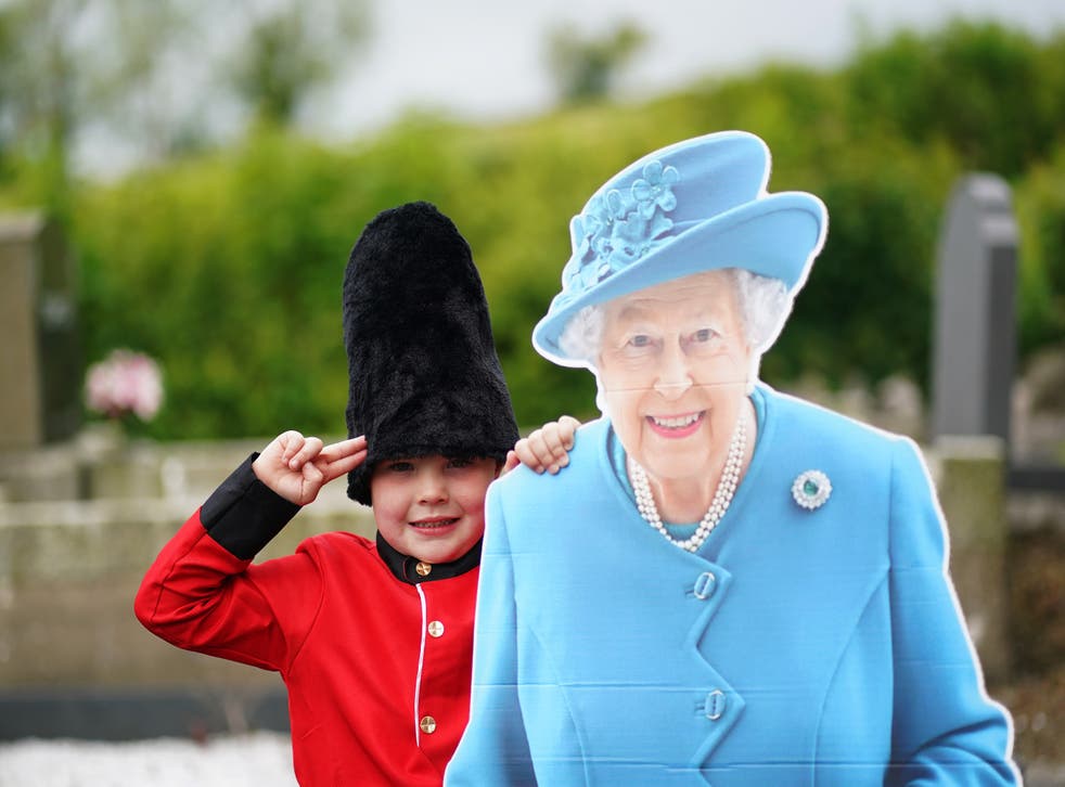 Noah McKnight, five dressed as a Foot Guard, with a cardboard cut-out of the Queen (Brian Lawless/PA)
