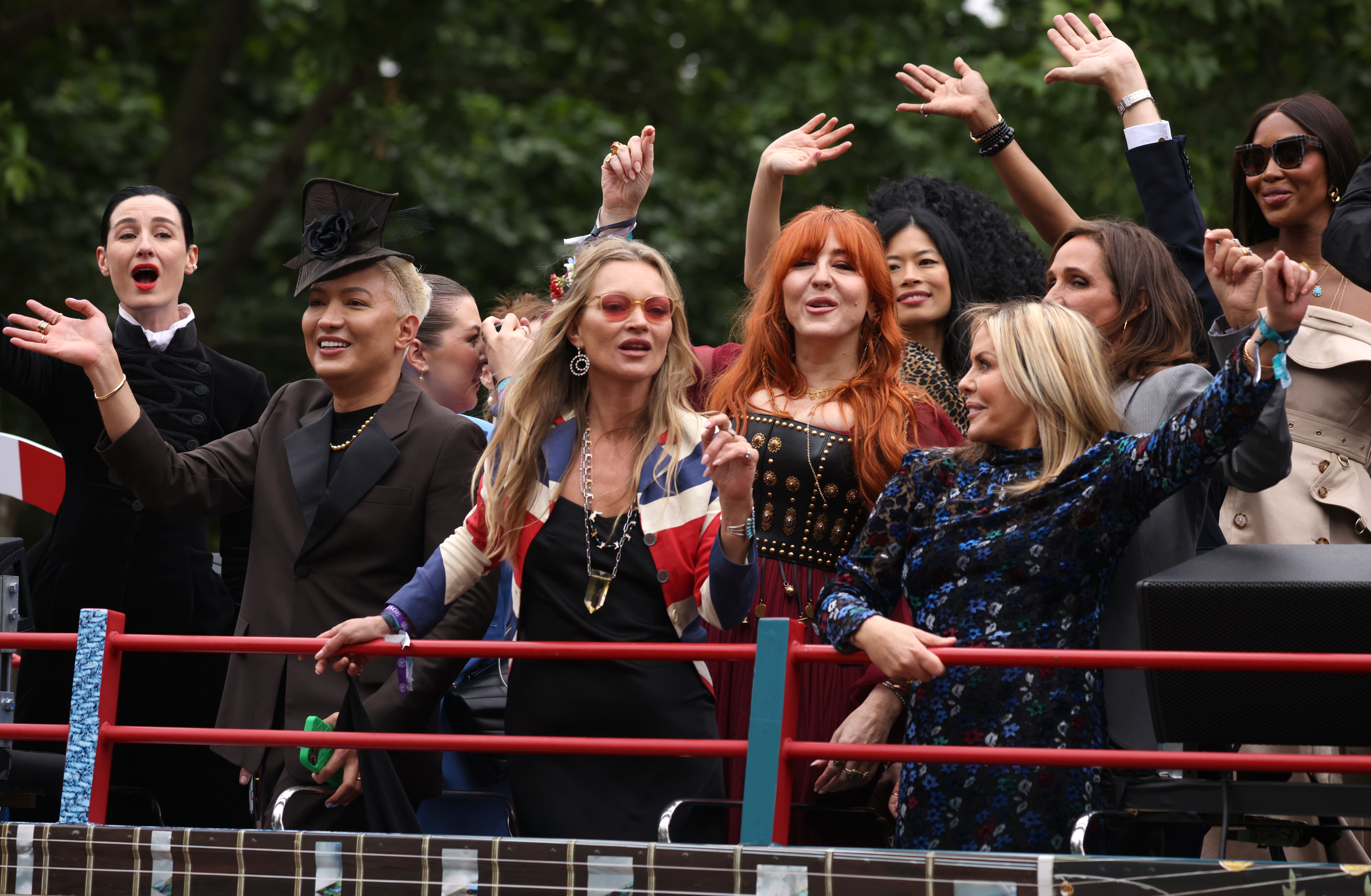 Erin O'Connor, Kate Moss, Charlotte Tilbury and Naomi Campbell wave at attendees