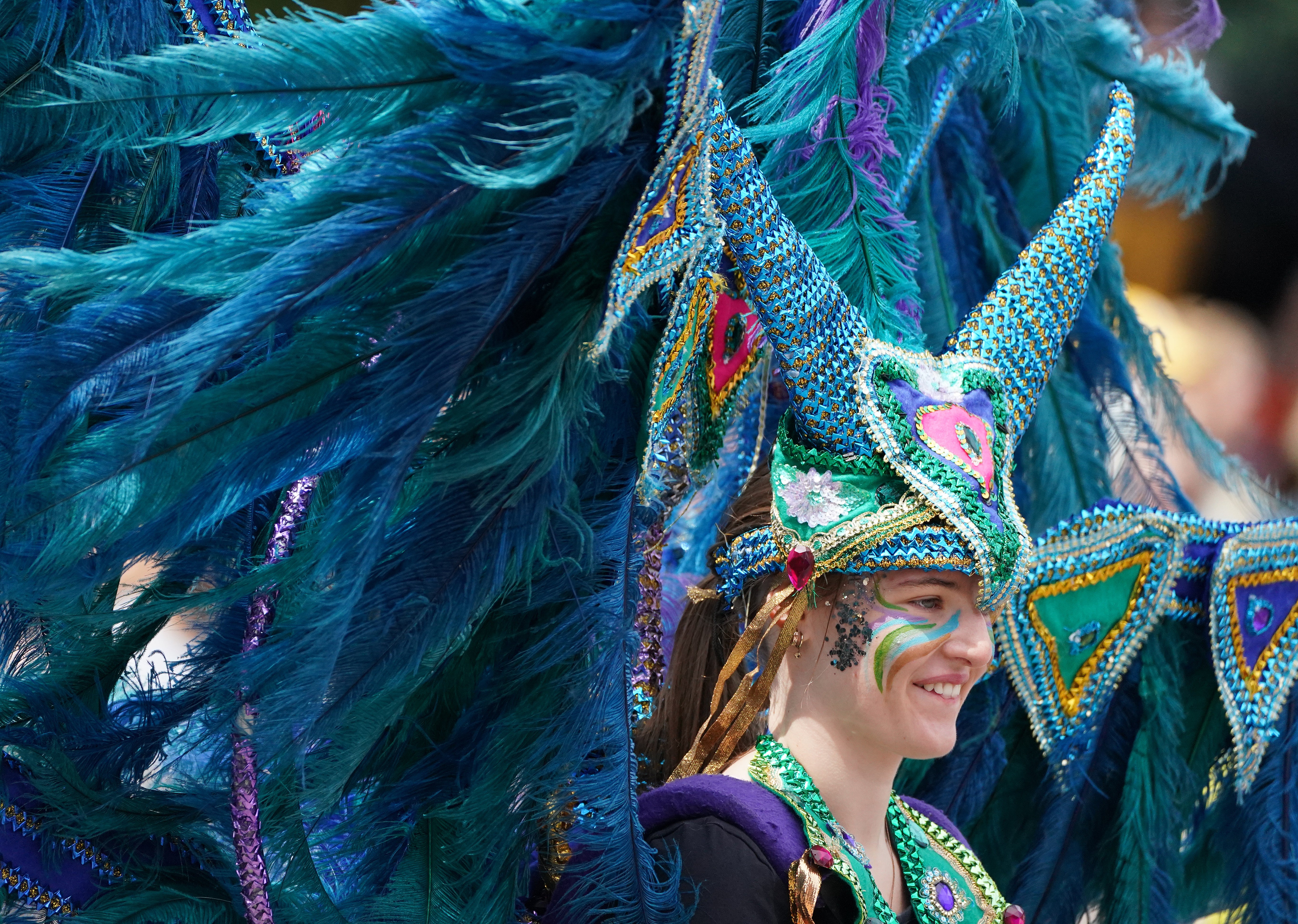 Performers from Edinburgh Festival Carnival parade entertain the crowds in Princess Street Gardens in Edinburgh (Andrew Milligan/PA)