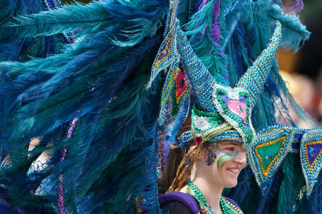 Performers from Edinburgh Festival Carnival parade entertain the crowds in Princess Street Gardens in Edinburgh (Andrew Milligan/PA)