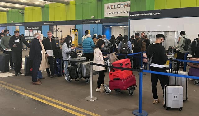 <p>Passengers queue outside Manchester Airport in June 2022 </p>