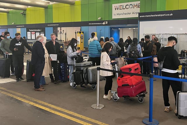 <p>Passengers queue outside Manchester Airport in June 2022 </p>