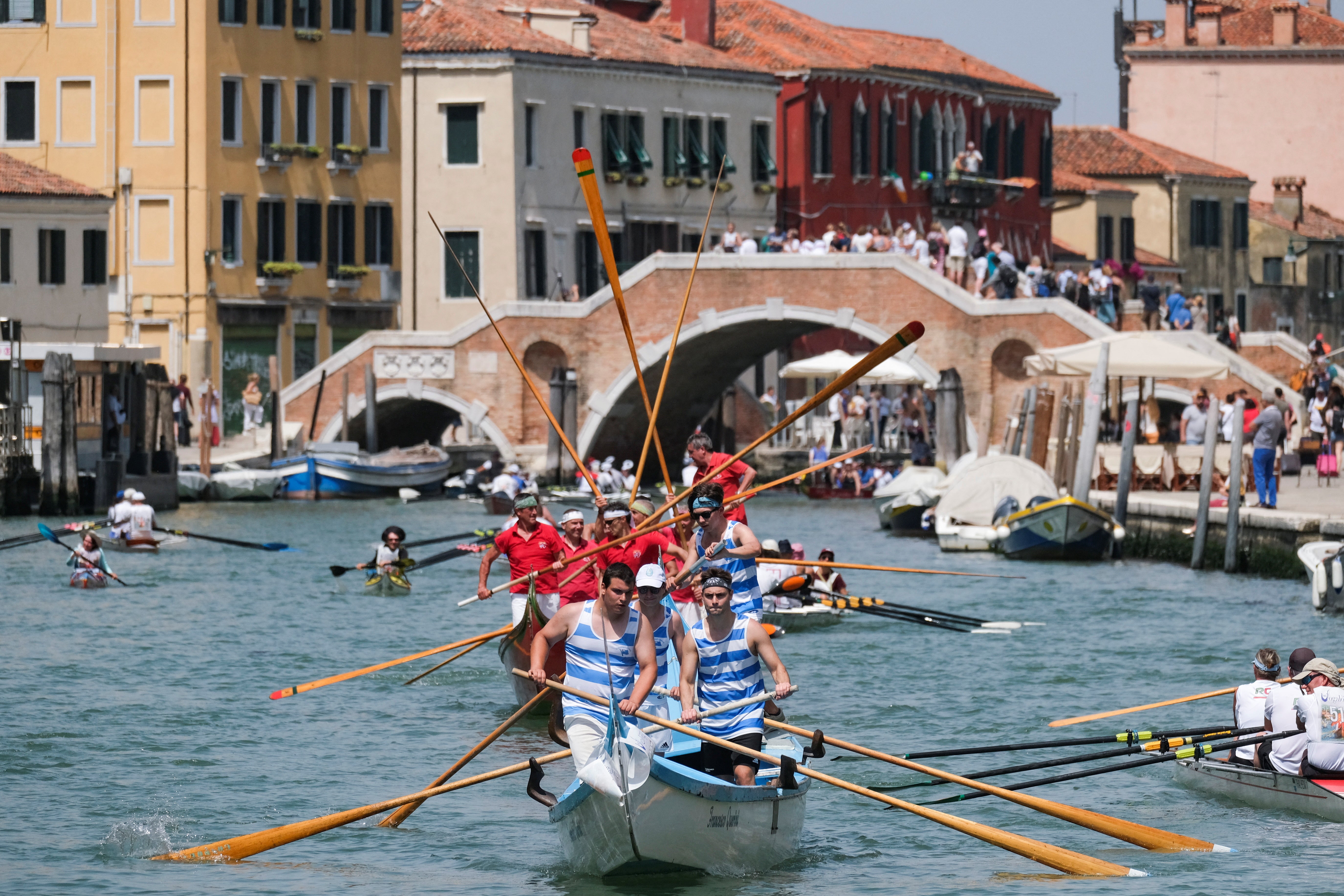 Rowers arrive at the Cannaregio Canal as part of the Vogalonga regatta in Venice