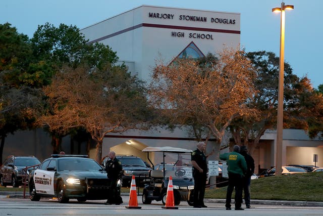 <p>Police officers outside Marjory Stoneman Douglass High School in Parkland, Florida on the one year anniversary of the 2018 mass shooting</p>