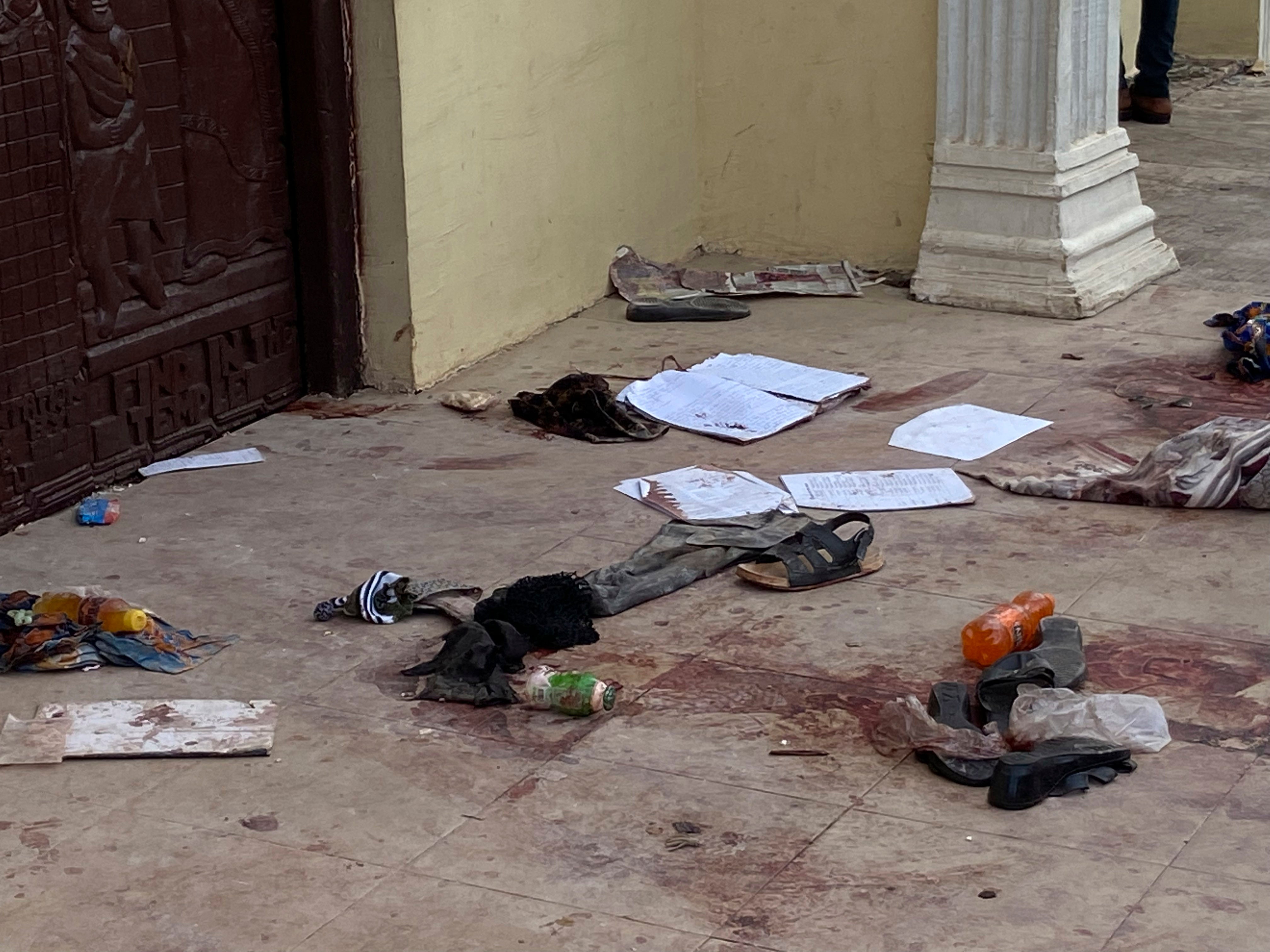 Shoes and personal belongings lie on the blood-soaked floor following the deadly attack