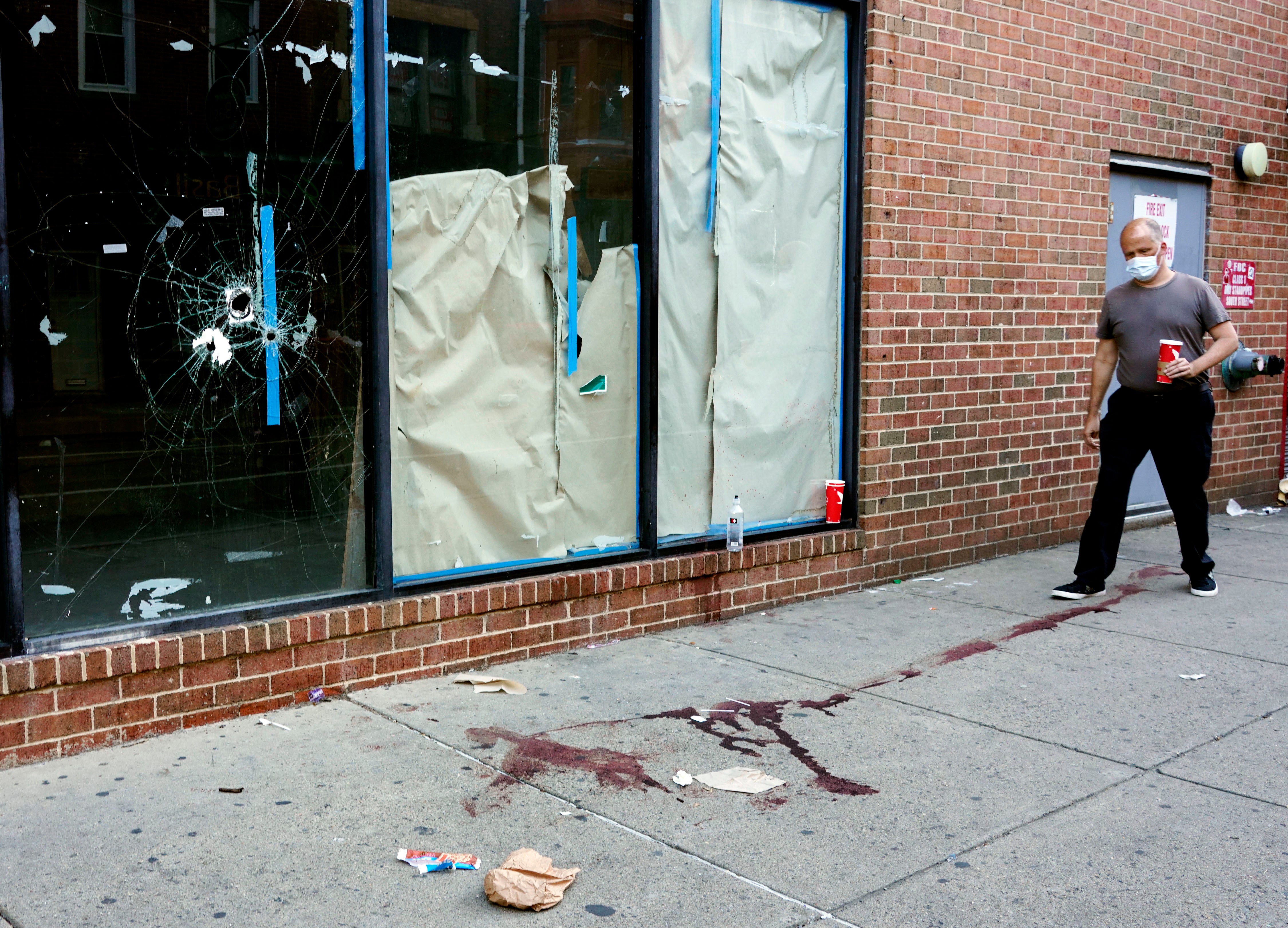 Bloodstains and bullet holes can be seen on South Street, Philadelphia