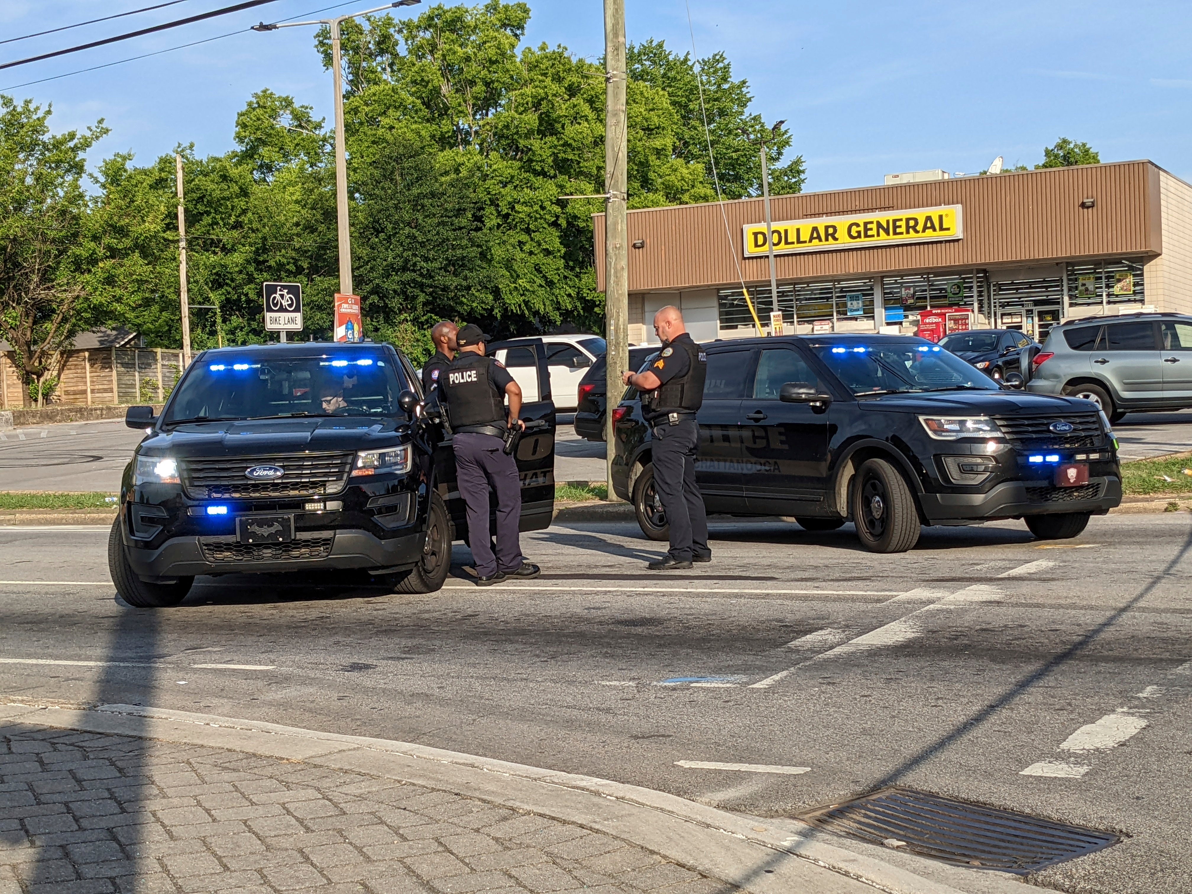 Officers stand near the scene of a mass shooting in Chattanooga on Sunday