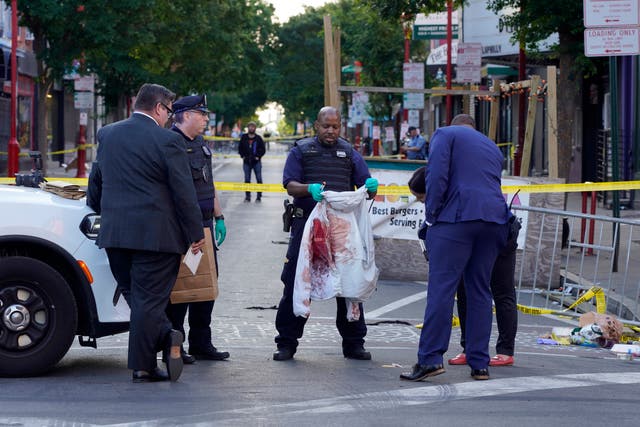 <p>Investigators at the scene of a fatal shooting in Philadelphia on Sunday</p>