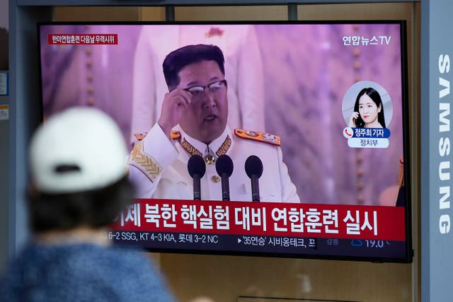 <p>File photo: A woman watches a TV screen showing a news program reporting about North Korea’s missile launch at a train station in Seoul, South Korea on 5 June</p>