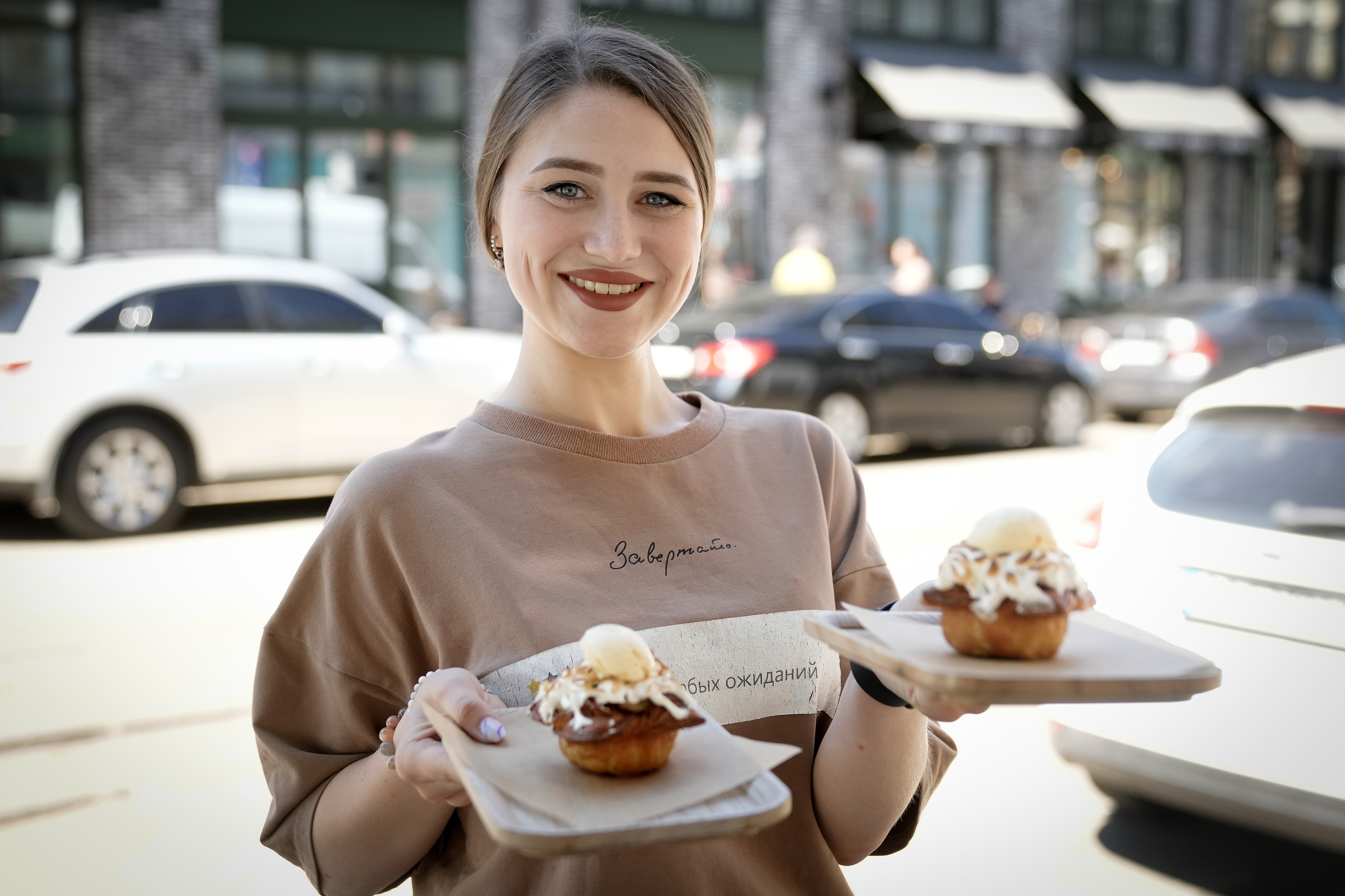 <p>A  waitress at the Zavertailo Cafe in Kyiv holds two cakes named after Boris Johnson</p>