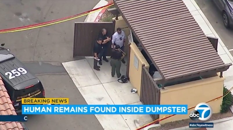 Officers on the scene after human remains were found inside a dumpster