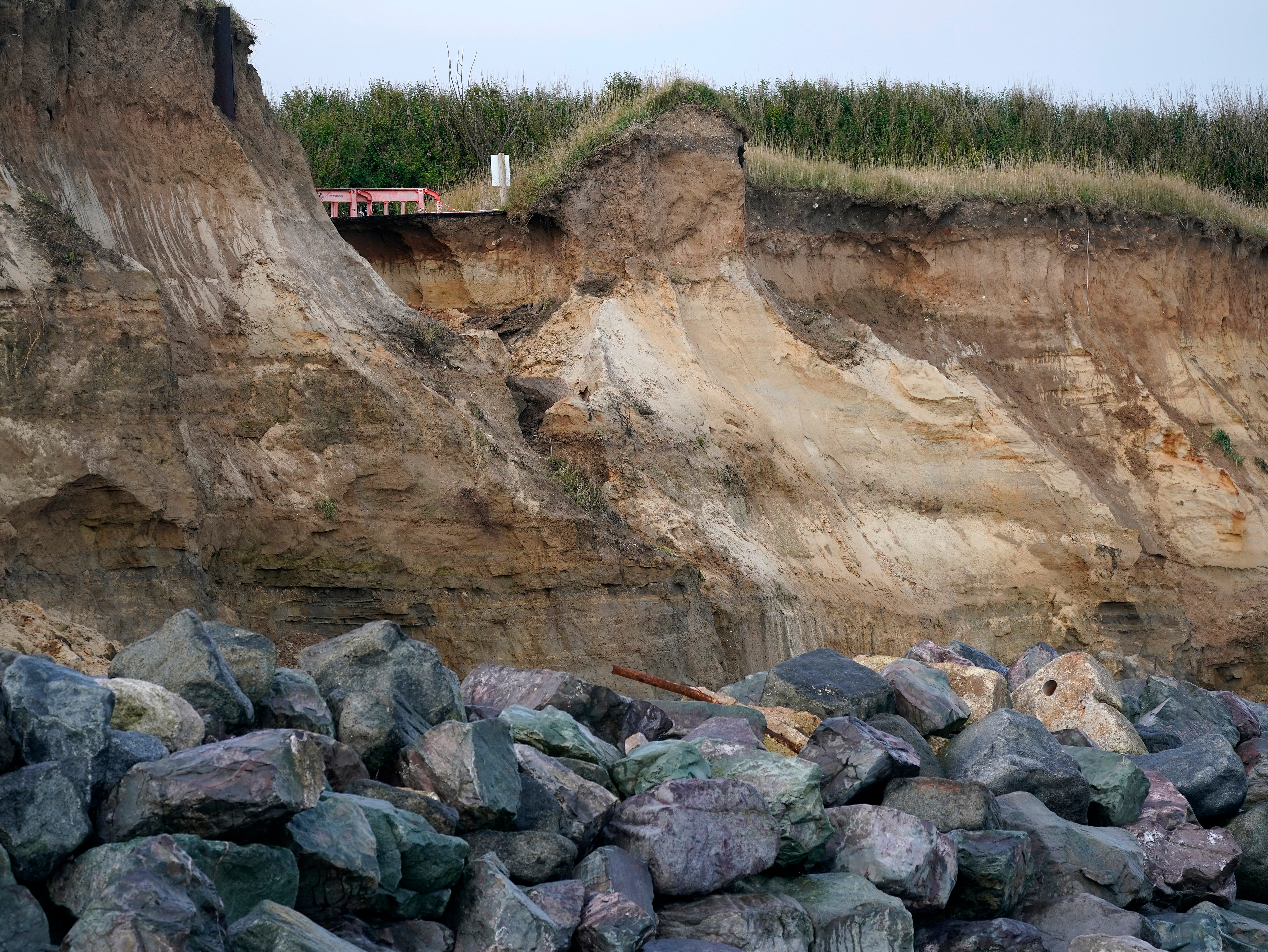The end of a tarmac road shows the devastation caused by coastal erosion of the cliff face in the village of Happisburgh, Norfolk in 2019