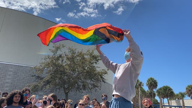 <p>Florida student Zander Moricz waves a Pride flag during a school walkout to protest what opponents have called the state’s ‘Don’t Say Gay’ law.</p>