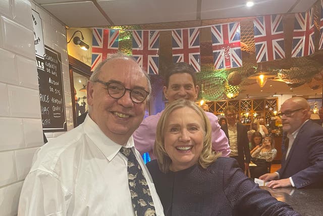 Hillary Clinton is greeted by Richard Ord senior, with former MP David Miliband behind, at Colman’s restaurant in South Shields (Richard Ord/PA)