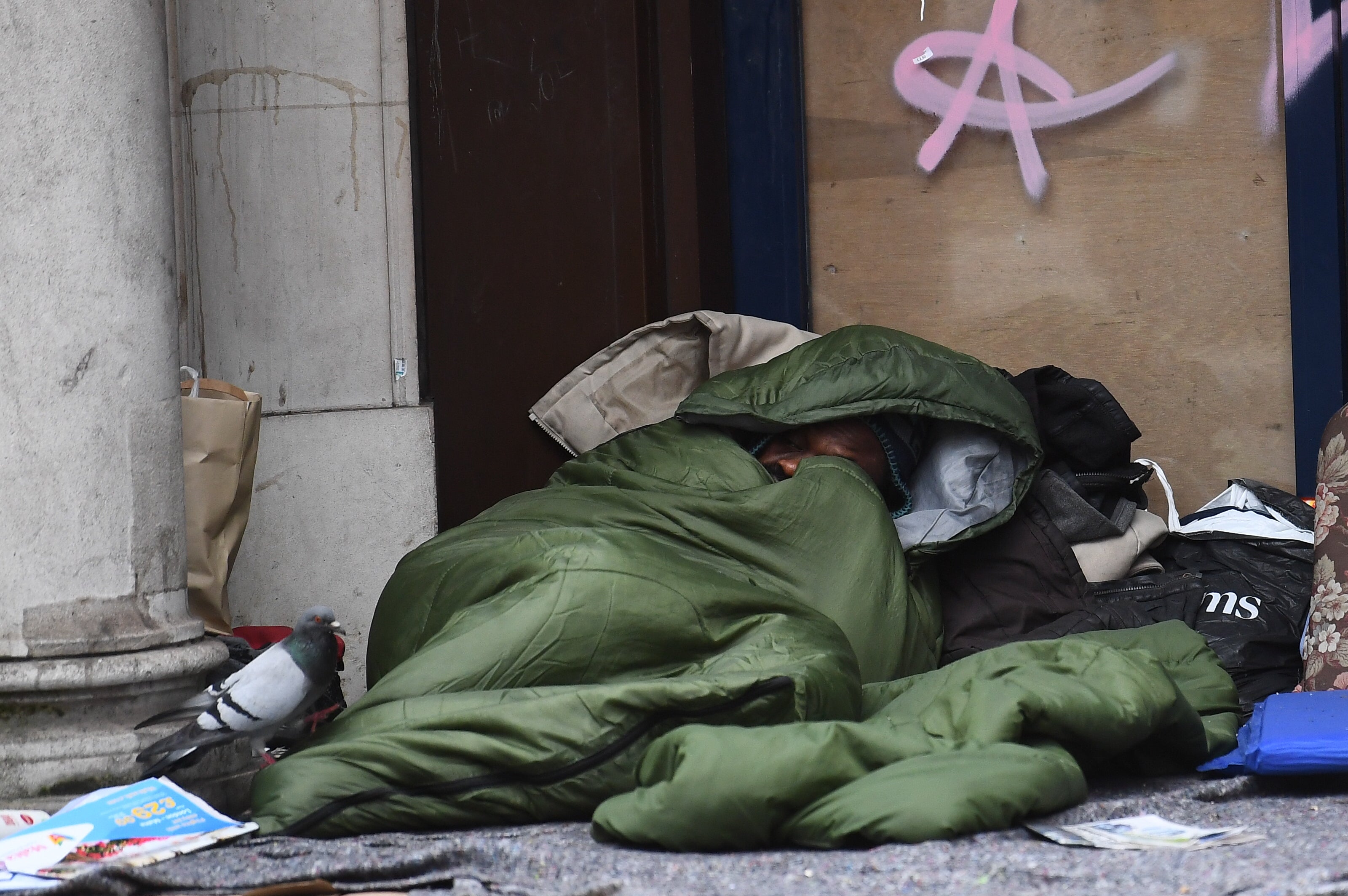 A homeless man sleeping in the doorway of closed down branch of a building society in London (Victoria Jones/PA)