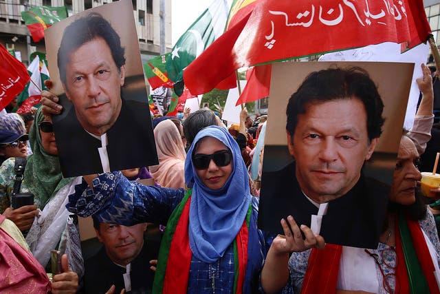 <p>Supporters of former prime minister Imran Khan hold placards as they shout slogans during a protest against inflation in Karachi on  3 June </p>