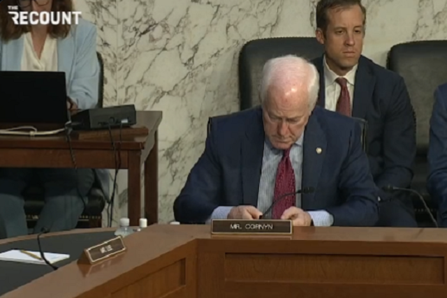 <p>Sen John Cornyn is spotted on his phone during a hearing of the Senate Judiciary Committee on domestic terrorism in response to the Buffalo shooting</p>