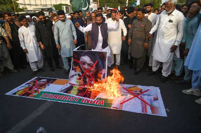 <p>Protestors in Karachi shout slogans and burn a picture of Nupur Sharma, the spokeswoman of India’s BJP, during a demonstration against her remarks on prophet Mohammed</p>
