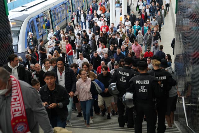 Football fans arrive at a nearby station ahead of the Germany v England Nations League game at Munich’s Allianz Arena (PA)