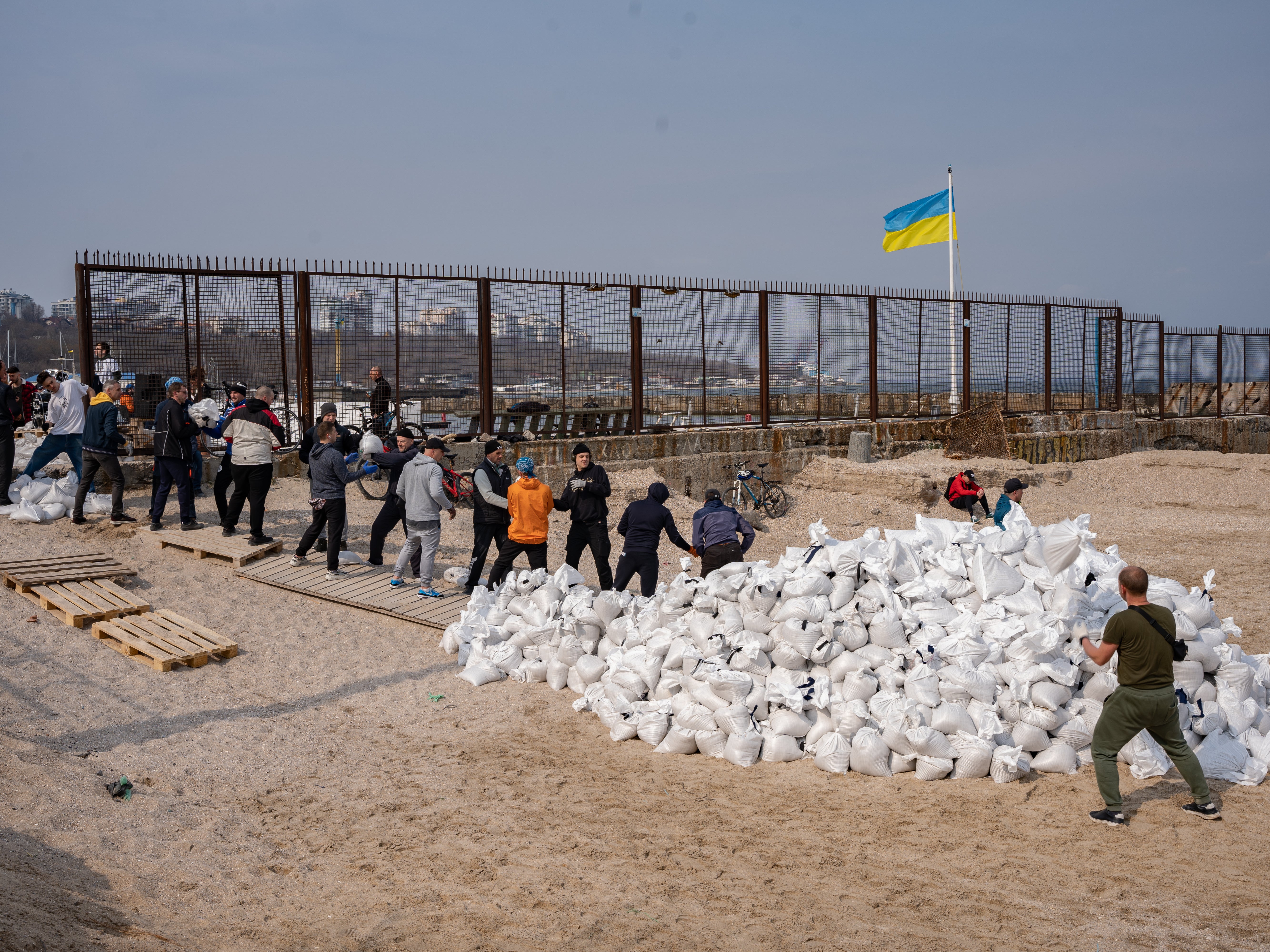 Volunteers transport sandbags from a beach in Odesa to soldiers on the front line