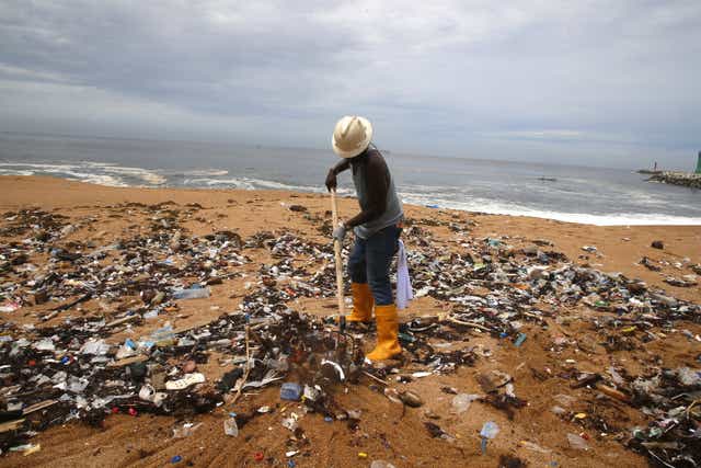 <p>A member of an environmental NGO cleans plastic debris on Vridi beach, a popular tourist destination in the city of Abidjan, Ivory Coast. Ocean plastic is pervasive global issue</p>
