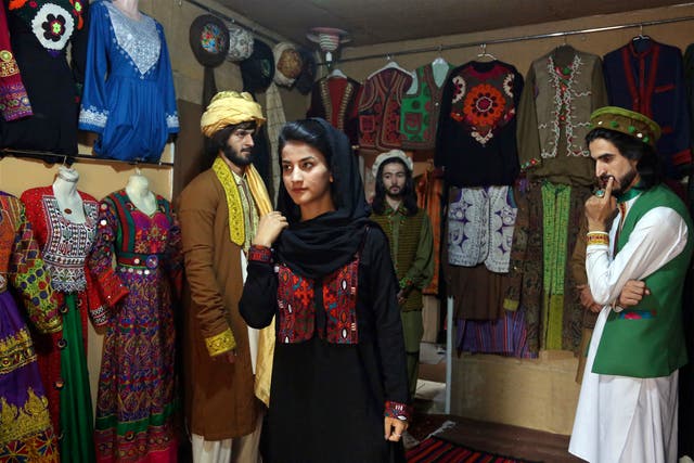 <p>File photo: Ajmal Haqiqi (right) watches as Mahal Wak practices modeling in Kabul, on 3 August 2017</p>