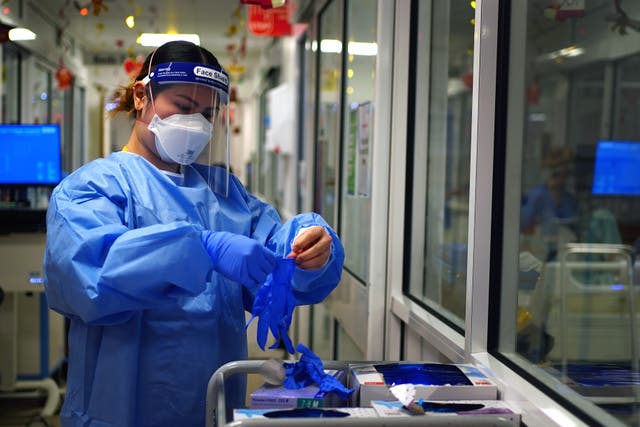 <p>File. A nurse puts on PPE in a ward for Covid patients at King’s College Hospital, in southeast London</p>