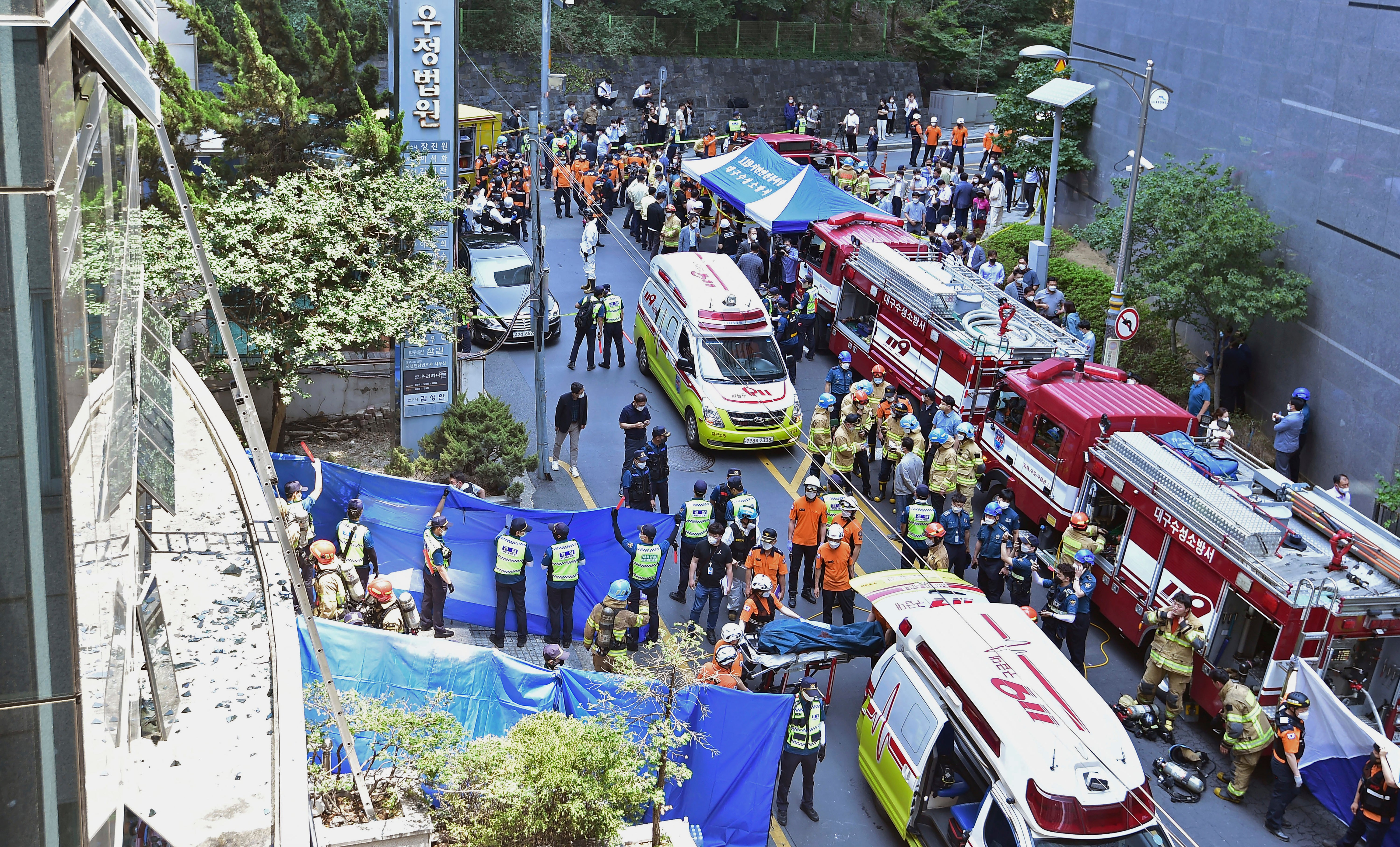 South Korean rescue teams and firefighters work at the scene in Daegu on 9 June
