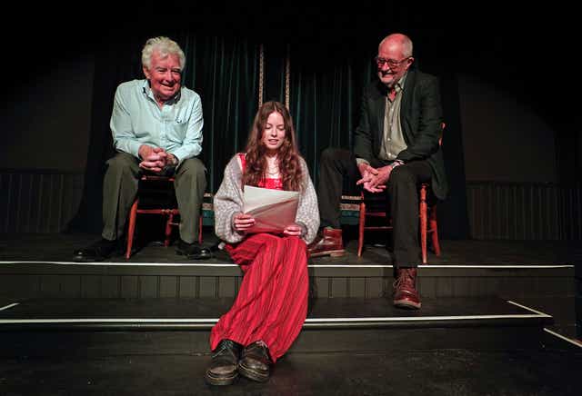 John Bright, costume designer and founder of The Bright Foundation (left) and actor Jim Broadbent (right) help Piper Wren with a rehearsal of a poem created for the launch of the Bright Foundation Barn Theatre and Museum at Rodgers Farm in Westfield, Hastings (Gareth Fuller/PA)