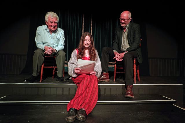 John Bright, costume designer and founder of The Bright Foundation (left) and actor Jim Broadbent (right) help Piper Wren with a rehearsal of a poem created for the launch of the Bright Foundation Barn Theatre and Museum at Rodgers Farm in Westfield, Hastings (Gareth Fuller/PA)